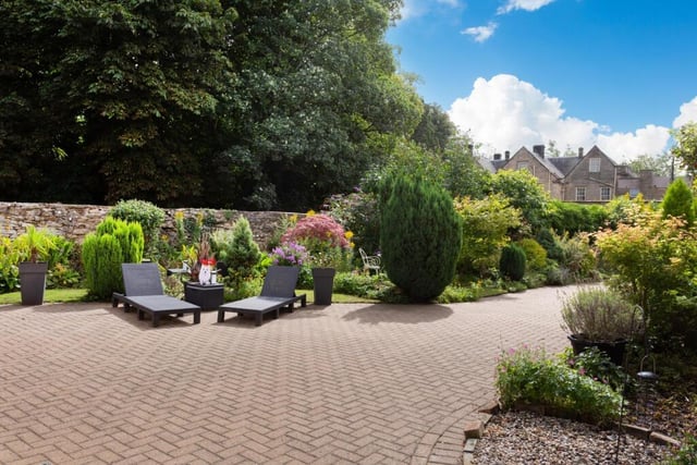 Established gardens include a choice of seating areas.
