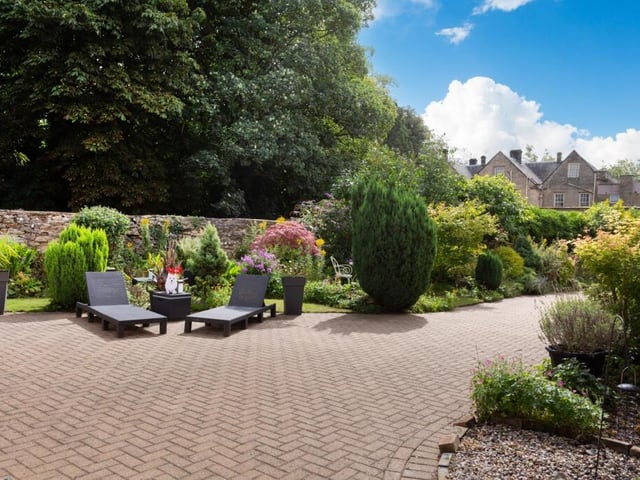 Established gardens include a choice of seating areas.