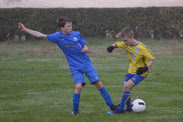 Heslerton Under-14s, in blue, take on Seamer