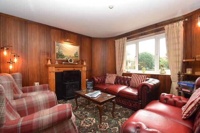 A guests' lounge, with fireplace and stove.