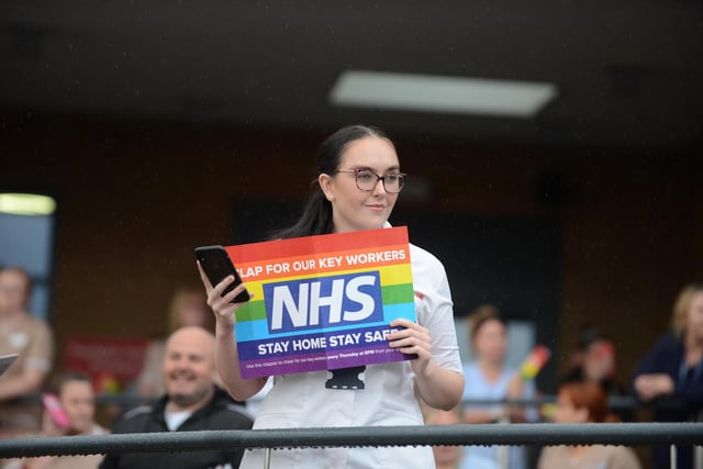 A staff member holds up a sign.