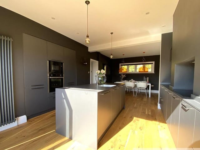 A deluxe modern kitchen with dining space.