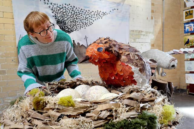 Debbie Hill with a section of the exhibition (credit: Richard Ponter)