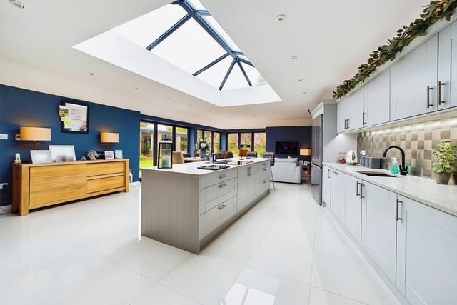 The lantern roof kitchen has a large central island, and granite worktops, with underfloor heating.