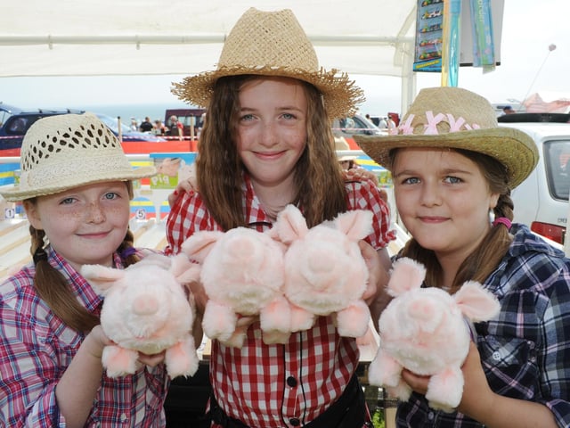 Rosie, 10, Aimee, 13, and Emily, 10, at the pig racing during the Lions Carnival.