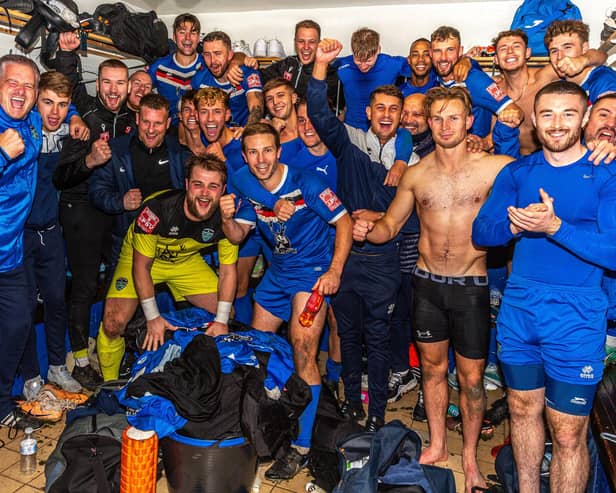 Whitby Town players and staff celebrate their FA Cup fourth qualifying round replay win at home to Chelmsford City. PHOTOS BY BRIAN MURFIELD