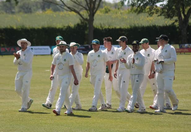 Luke Smith (white hat centre) leads off Stamford Bridge after taking 6-17 to destroy Woodhouse Grange 2nds. Photo by Phil Gilbank