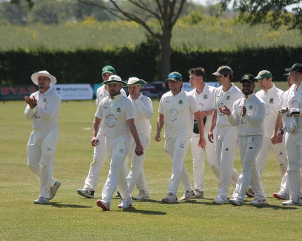 Luke Smith (white hat centre) leads off Stamford Bridge after taking 6-17 to destroy Woodhouse Grange 2nds. Photo by Phil Gilbank