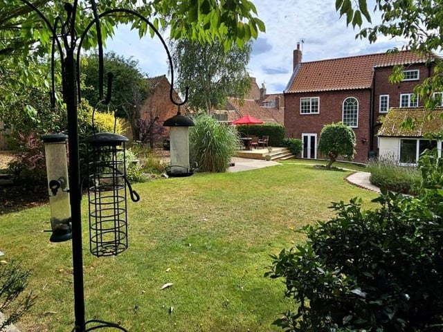 A rear view of the house from its lovely gardens.