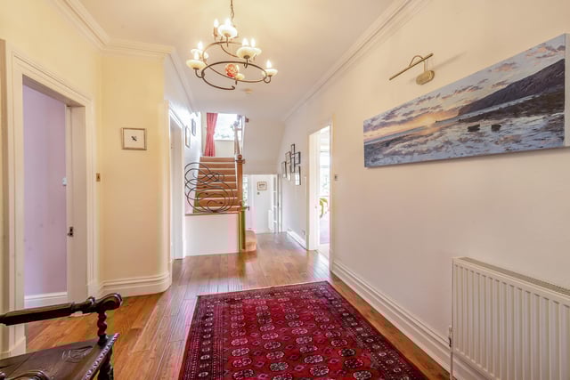 The hallway, with wooden floor, has front and rear porches with outdoor access.