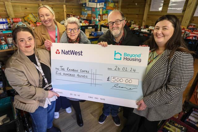 Beyond Housing colleagues (from left) Georgia Raines and Stephanie Lake present a cheque for £500 to (from 3rd left) Rainbow Centre CEO Jo Laking, Operations Manage Mike Lynskey, Customer Support Manager Rose Randerson.