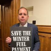 Charlie Dewhirst MP for Bridlington and the Wolds, with his Save the Winter Fuel Payment placard.
