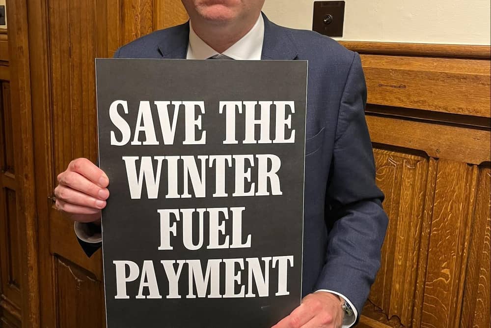 Charlie Dewhirst MP for Bridlington and the Wolds, with his Save the Winter Fuel Payment placard.