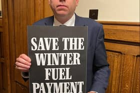 Charlie Dewhirst MP for Bridlington and the Wolds, with his Save the Winter Fuel Payment placard.