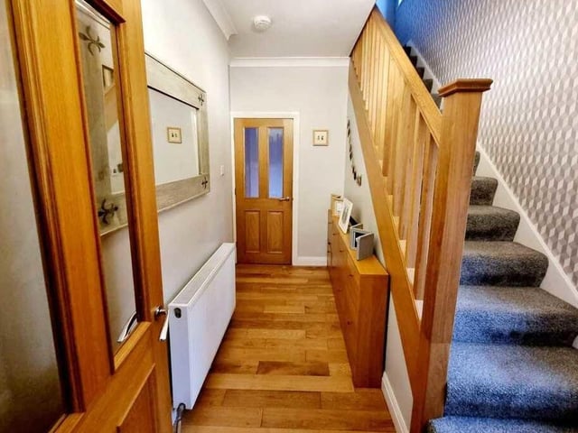 The entrance hallway has stairs up to the first and then the second floor.