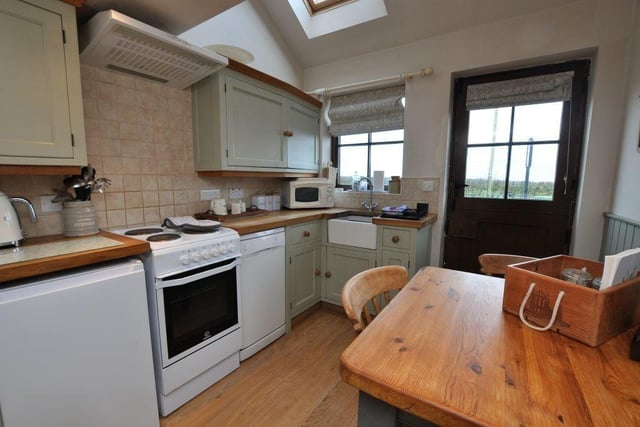 The kitchen with diner has hand-made shaker cabinetry with solid oak worktops.