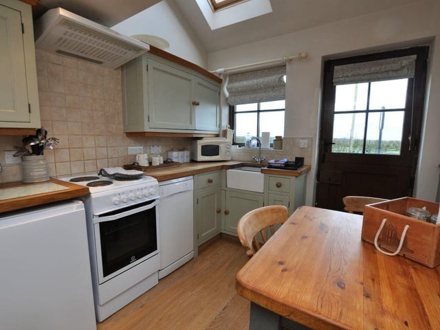 The kitchen with diner has hand-made shaker cabinetry with solid oak worktops.