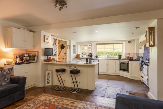 The large and stylish kitchen with breakfast bar links to open plan living and dining areas.