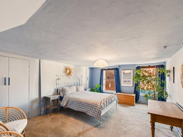 An airy double bedroom has inbuilt storage.
