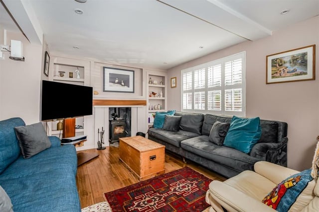 The sitting room has a feature fireplace with log burner.