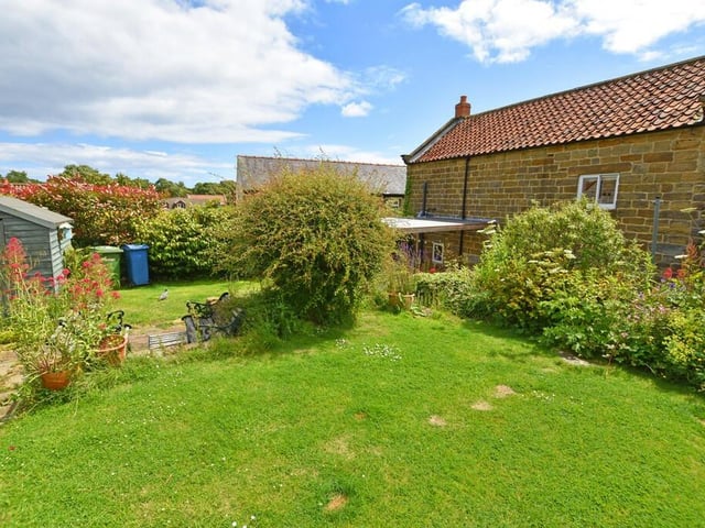A full view of the lawned garden with established borders.