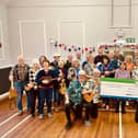 The Eskuleles present a cheque for £2,000 to the Great North Air Ambulance.