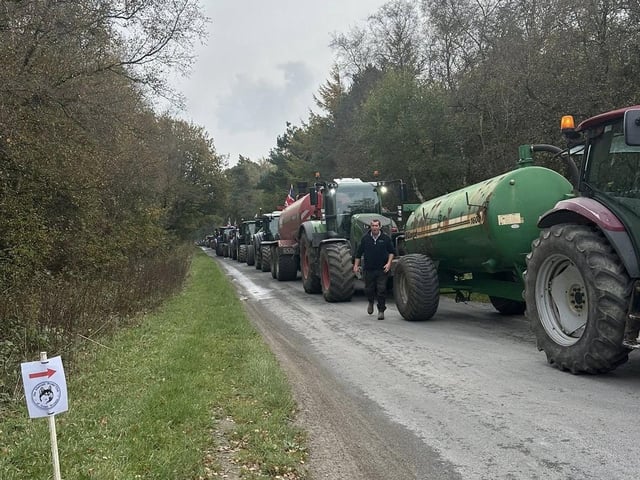 Convoy of tractors on the road.