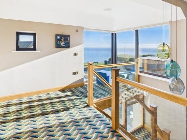 A glazed corner space on the first floor landing gives expansive views of sea and coastline.