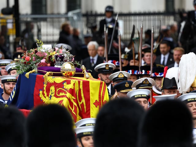 The coffin of Britain's Queen Elizabeth is carried in the procession to Westminster Abbey. (Photo by Hannah McKay- WPA Pool/Getty Images)