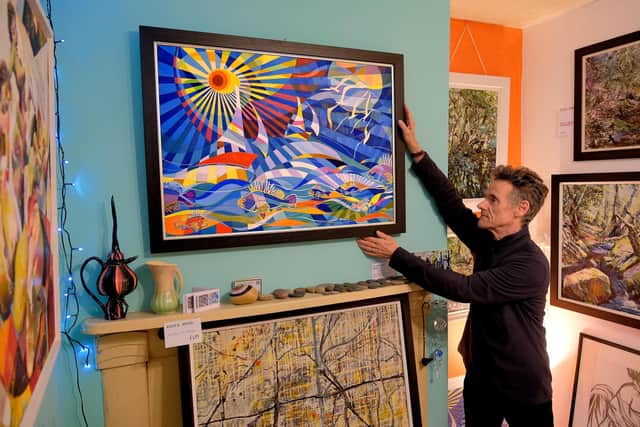 Simon Dawson arranging his work.