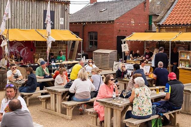 Photos in a very full courtyard at Whitby Brewery.