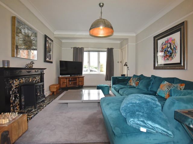 The spacious lounge has a central feature fireplace.