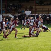 Will Vasey is tackled by a home player. Photo by Charlie Hopper