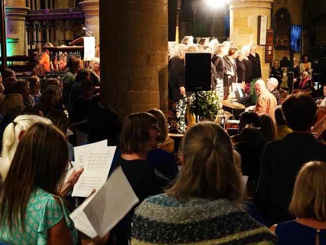 A mass of six choirs perform all together in the finale of the Community Choir evening at St.Mary's Church.