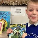 Coby Mortimer, 6, with the book he has written.