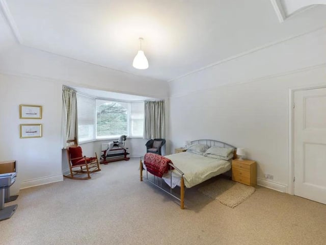 One of the five bedrooms showcasing a beatiful bay window.