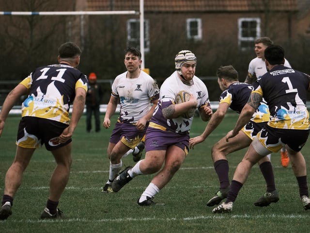 A Pirates player looks to force his way through