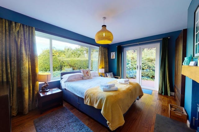 A stunning ground floor bedroom with en suite and doors out to the gardens.