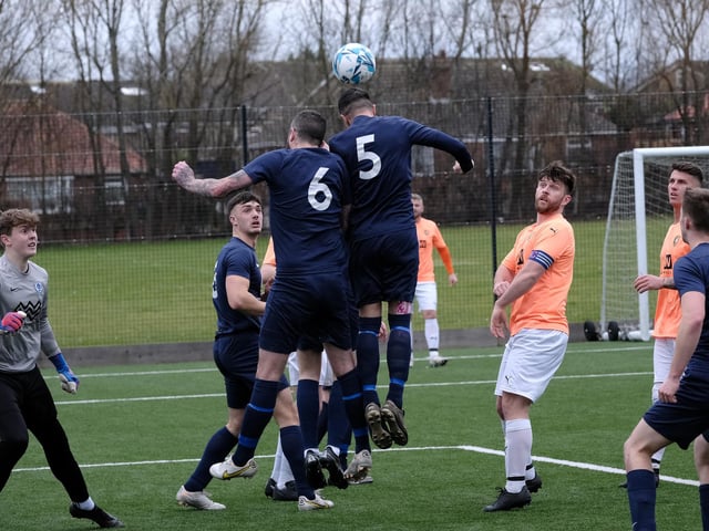 Edgehill skipper Joe Gallagher looks on while Haxby Town head the ball clear