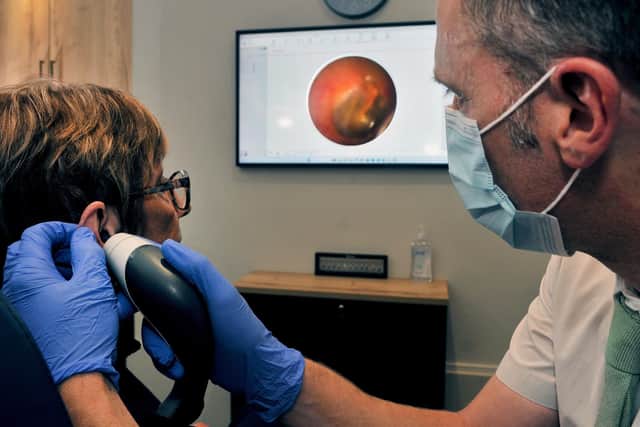 Ear examination with video otoscope.
