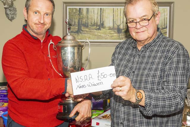 The WSAA Christmas match winner Christmas Match Davey Turnbull is presented with his trophy and £50 cash prize by treasurer Dave Perrett. Photo by Peter Horbury