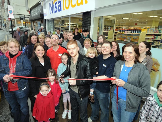 Coronation Street actor Mikey North, centre, cuts the ribbon to officially open the new Nisa Store.