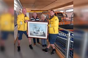 Paul and Ivy pictured with the Don Micklethwaite painting and two Bridlington RNLI volunteers. Photo courtesy of Bridlington RNLI.
