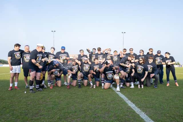 Scarborough RUFC players and coaches celebrate with champagne after clinching the Regional 2 North East title last weekend. Photo by Andy Standing