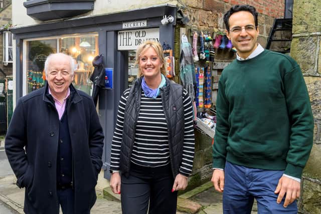 The owner of the Old Drapery in Robin Hood’s Bay, Holly Gray, with the chairman of North Yorkshire Council, Cllr George Jabbour, left, and the leader of North Yorkshire Council, Cllr Carl Les, right, outside the shop which is at the end of the Coast to Coast route.