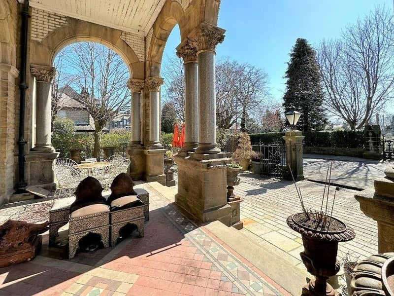 The grand entrance to Chapel House is through the front courtyard garden and an Italianate portico to the arched doorway.