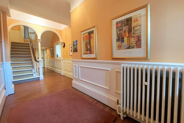 One of the spacious hallways, with feature arches and wall panelling, within the townhouse.