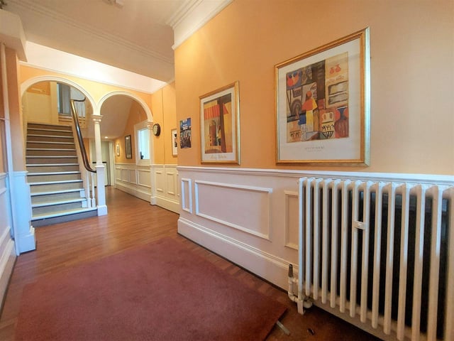 One of the spacious hallways, with feature arches and wall panelling, within the townhouse.