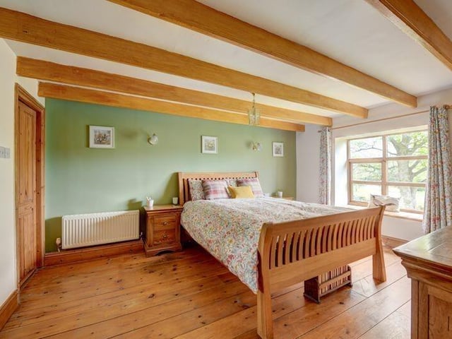 A beamed double bedroom with garden views.