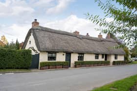The exterior of the grade ll thatched cottage.